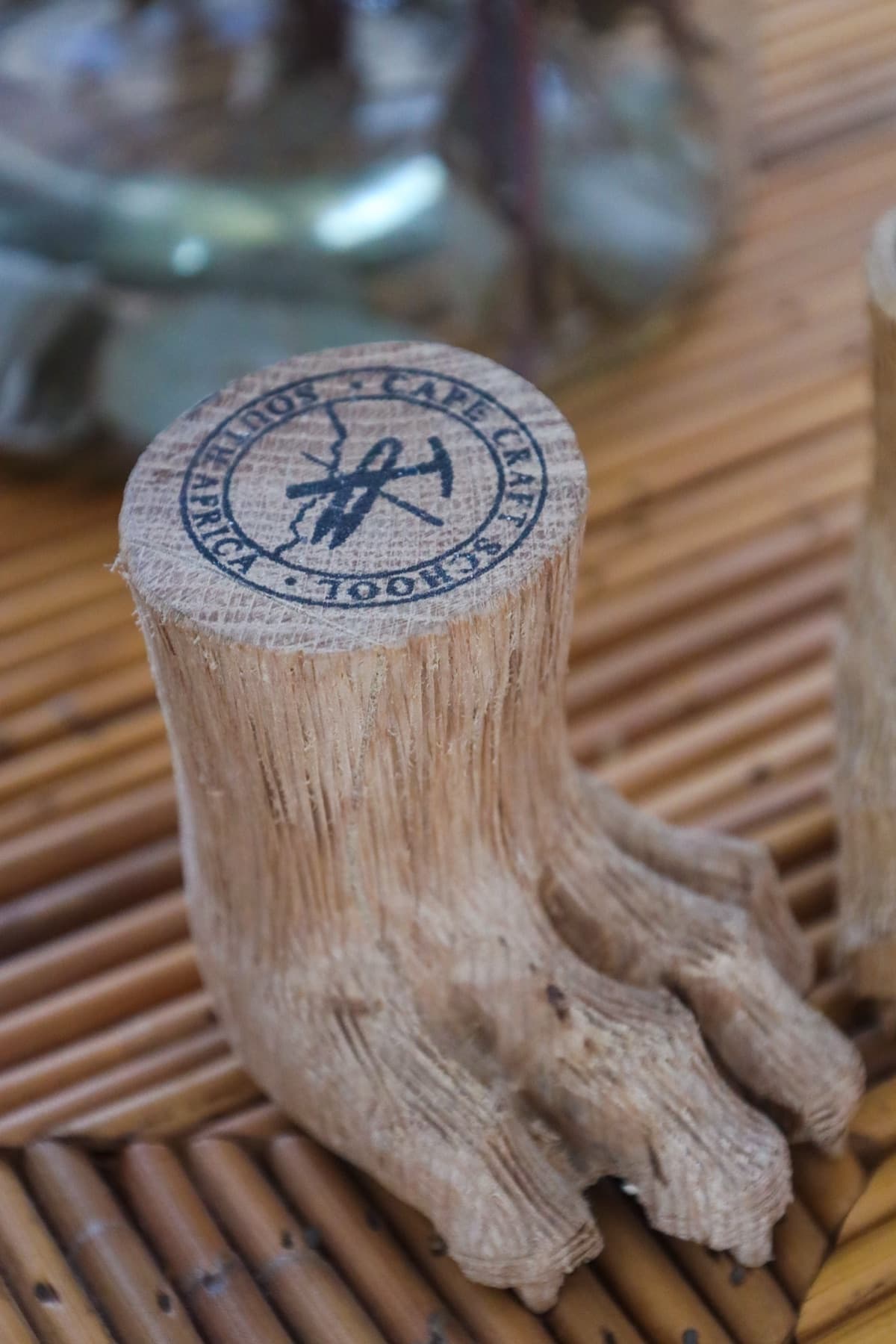 A carved wooden piece marked with the Craft School South Africa seal