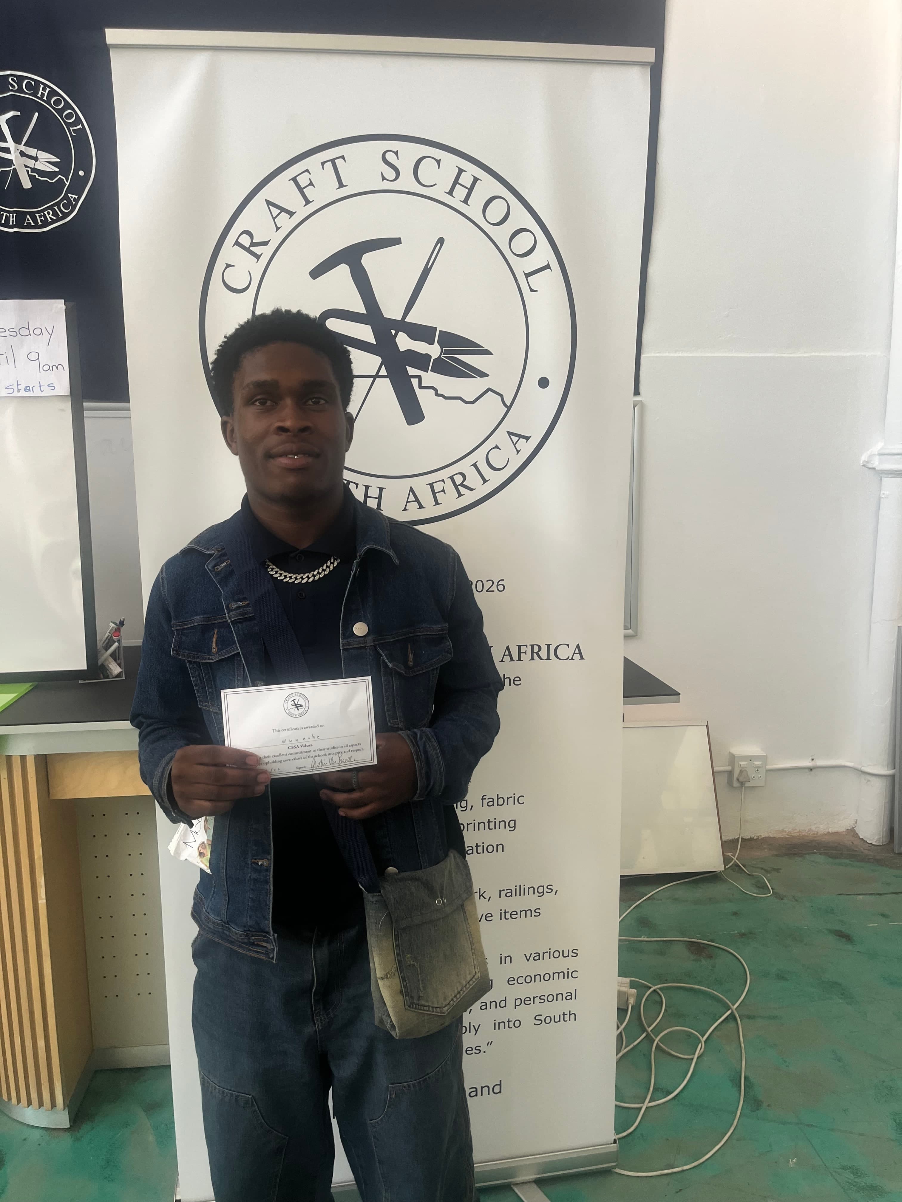 A Craft School student with his Term 1 certificate