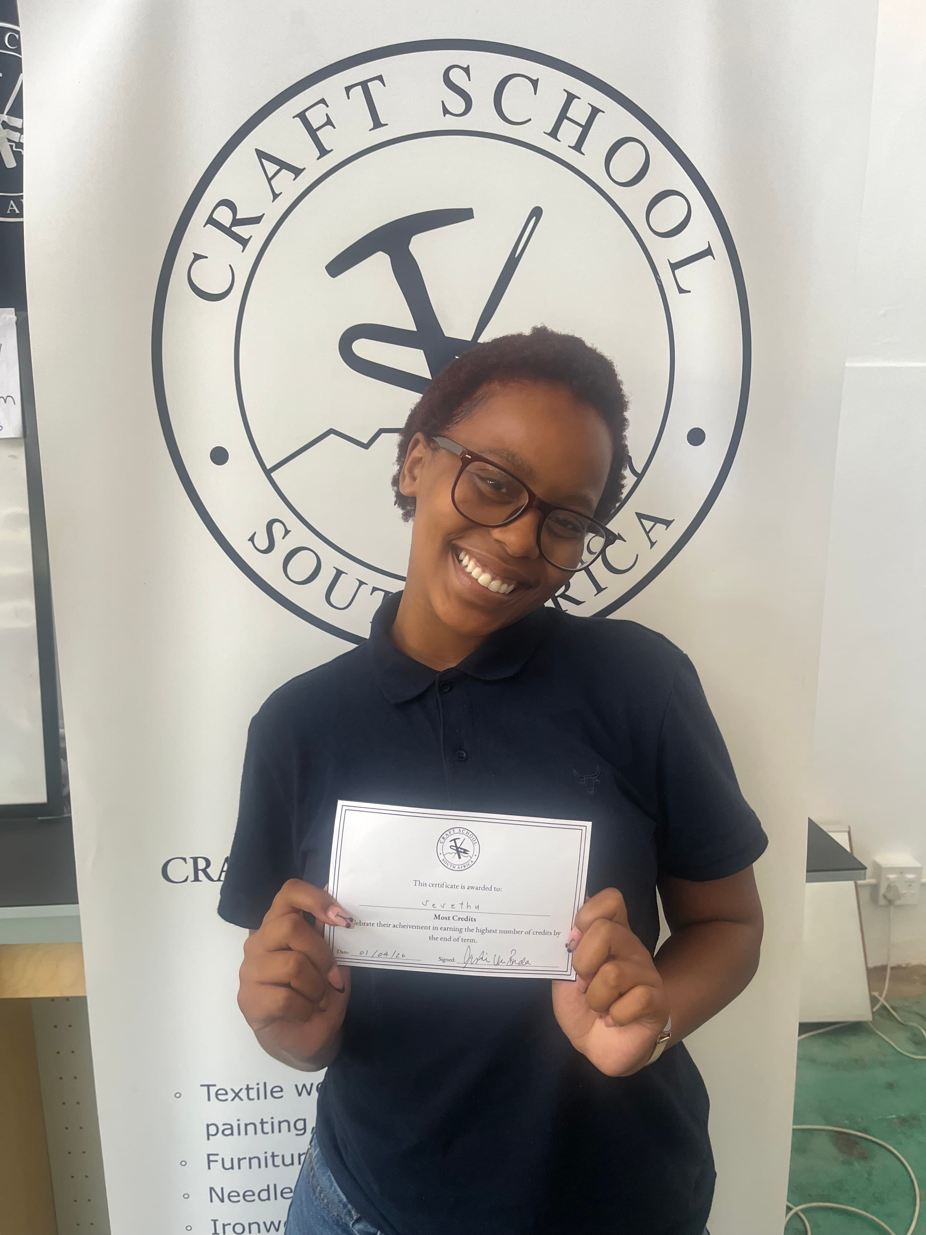 A Craft School student celebrating her Most Credits award