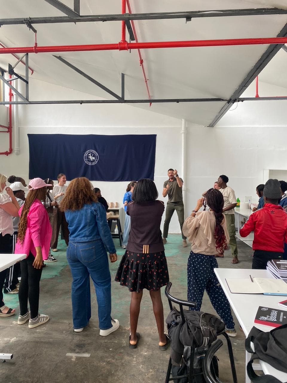 Justin van Breda speaking with students in the Woodstock workshop